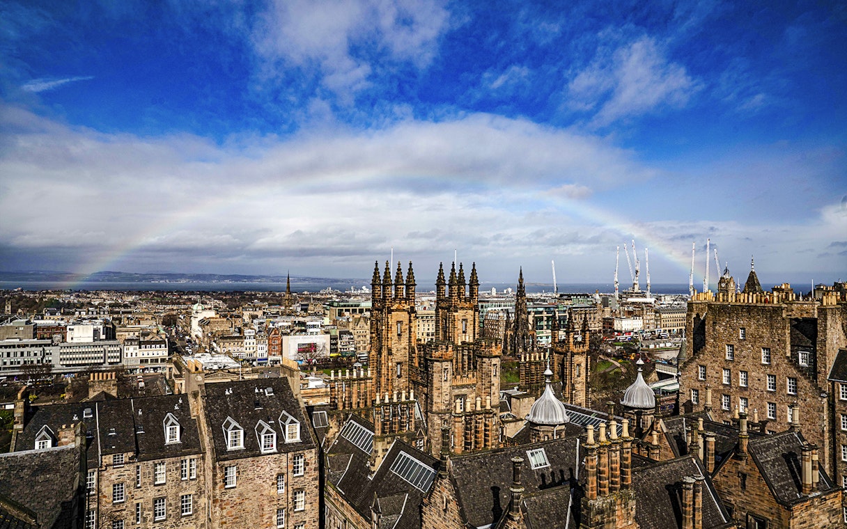 Edinburgh skyline with historic buildings and rainbow from Camera Obscura & World of Illusions.