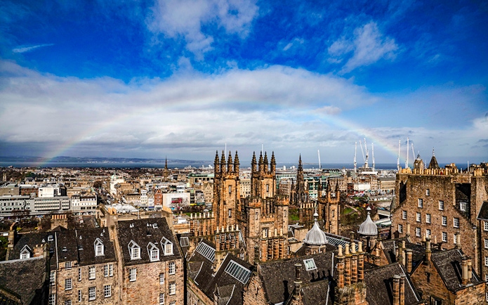 Edinburgh skyline with historic buildings and rainbow from Camera Obscura & World of Illusions.