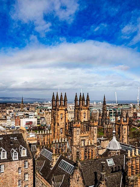 Edinburgh skyline with historic buildings and rainbow from Camera Obscura & World of Illusions.