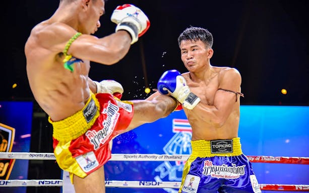 Muay Thai fighters in action at Patong Boxing Stadium, Thailand.