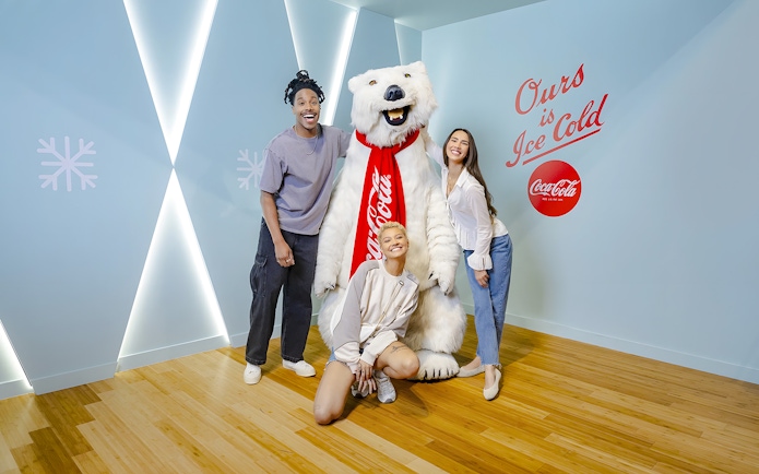 Friends posing with Coca-Cola bear at Coca-Cola Museum, Atlanta.