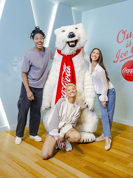 Friends posing with Coca-Cola bear at Coca-Cola Museum, Atlanta.