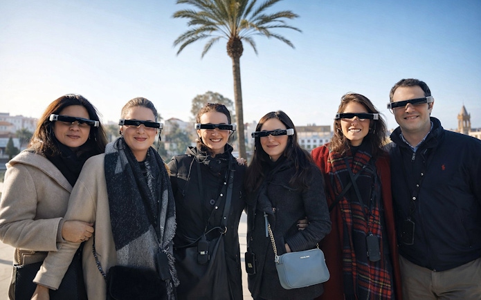 Tourists with guide wearing smart glasses during Setas de Sevilla city tour.