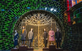 Mannequins in front of ornate gate at Ministry of Magic set, Warner Bros. Studio Tour Tokyo.