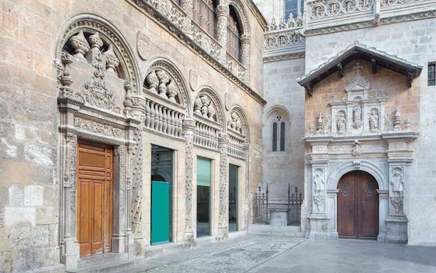 Granada Cathedral ornate stone facade with detailed carvings and arched doorways.