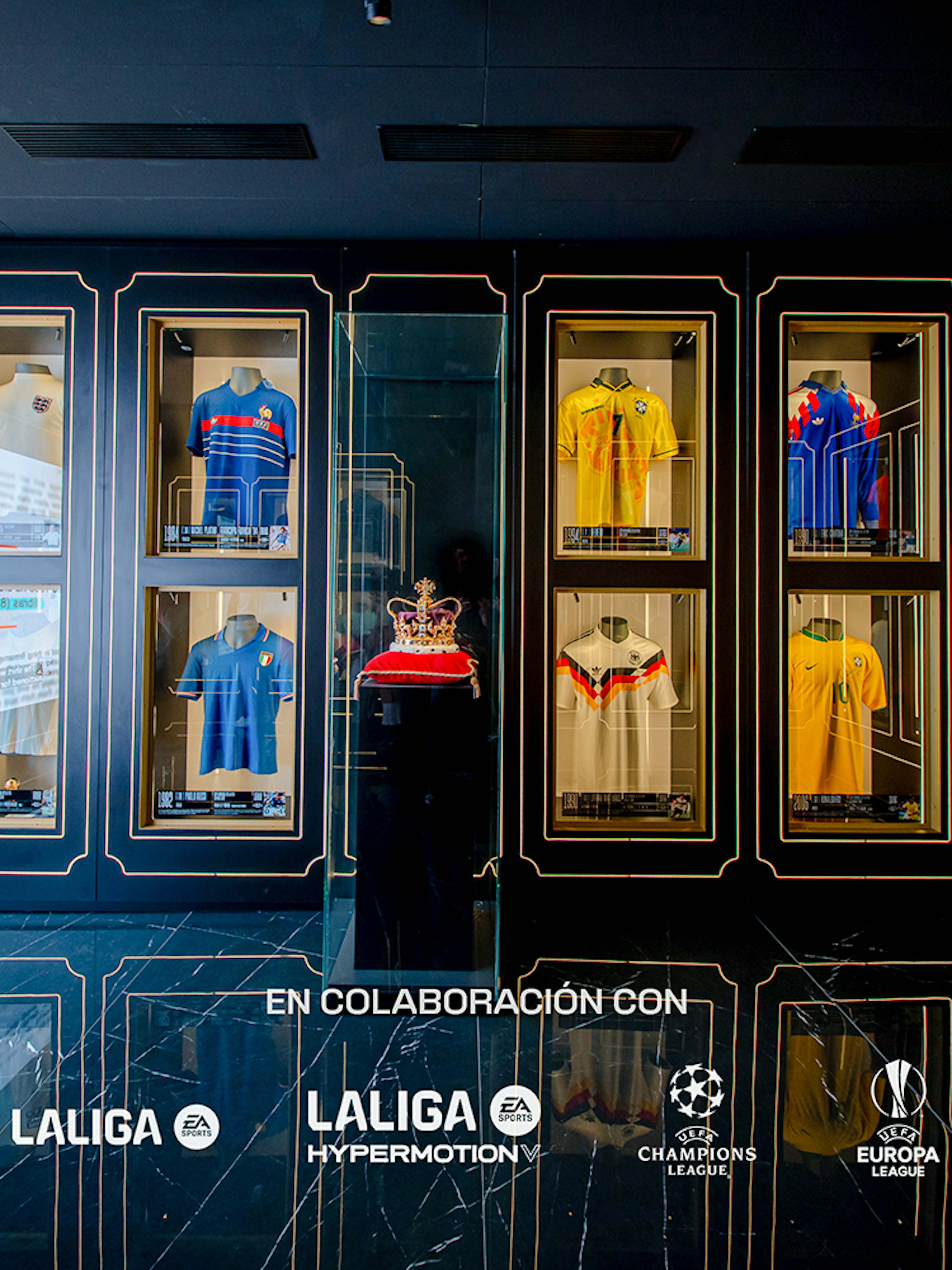 Football jerseys displayed in glass cases at the Legends of Football Museum.