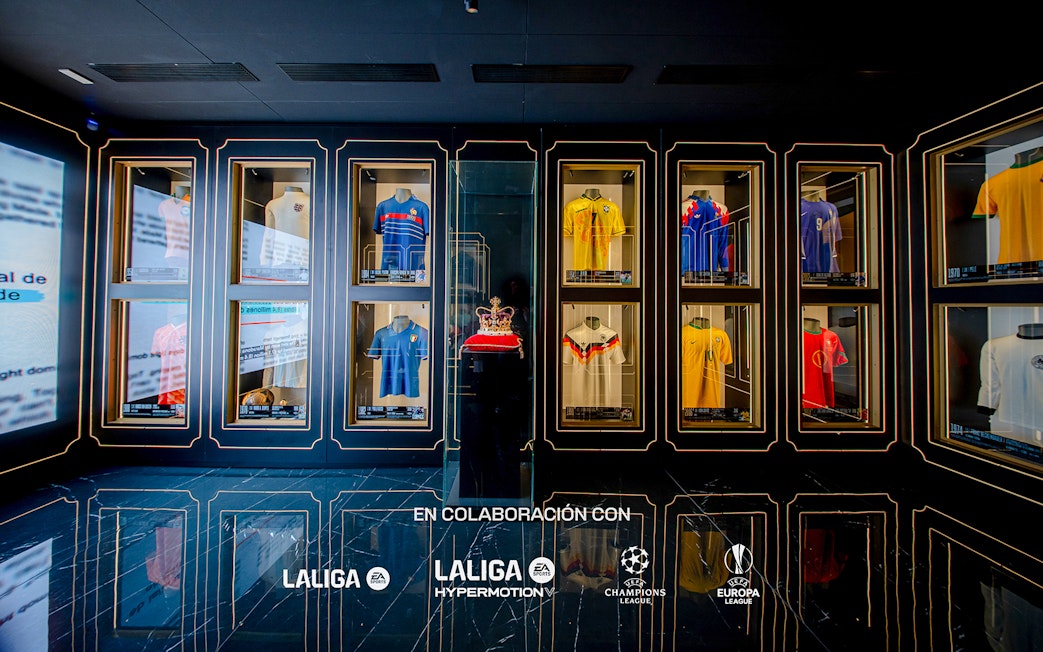 Football jerseys displayed in glass cases at the Legends of Football Museum.