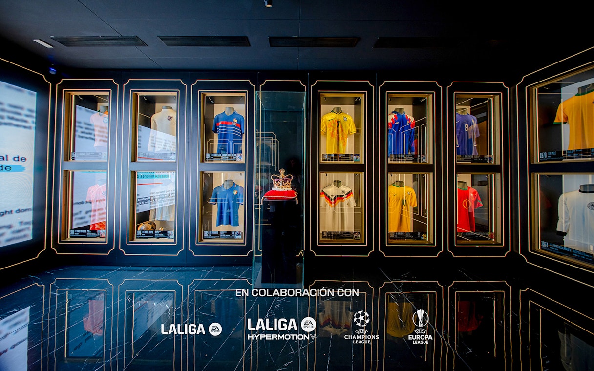 Football jerseys displayed in glass cases at the Legends of Football Museum.