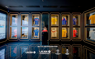 Football jerseys displayed in glass cases at the Legends of Football Museum.