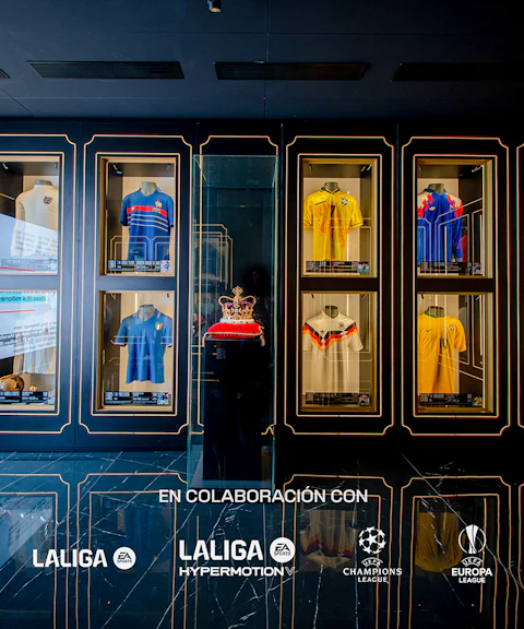 Football jerseys displayed in glass cases at the Legends of Football Museum.
