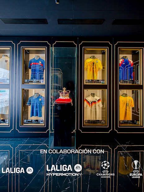 Football jerseys displayed in glass cases at the Legends of Football Museum.