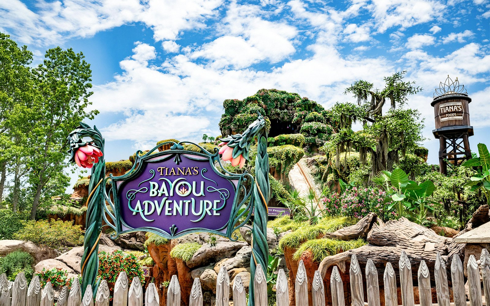 Tiana's Bayou Adventure entrance sign with lush greenery at Walt Disney World Resort, Orlando.