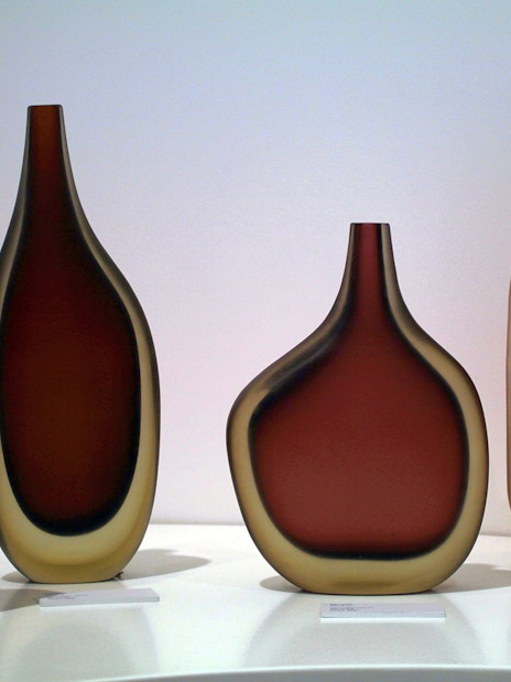 Venetian glass vases displayed in a museum, part of the Venice Museums Pass.