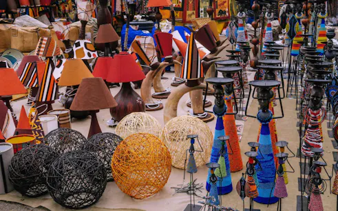 Colorful handicrafts and lamps at a Nairobi market during city excursion.
