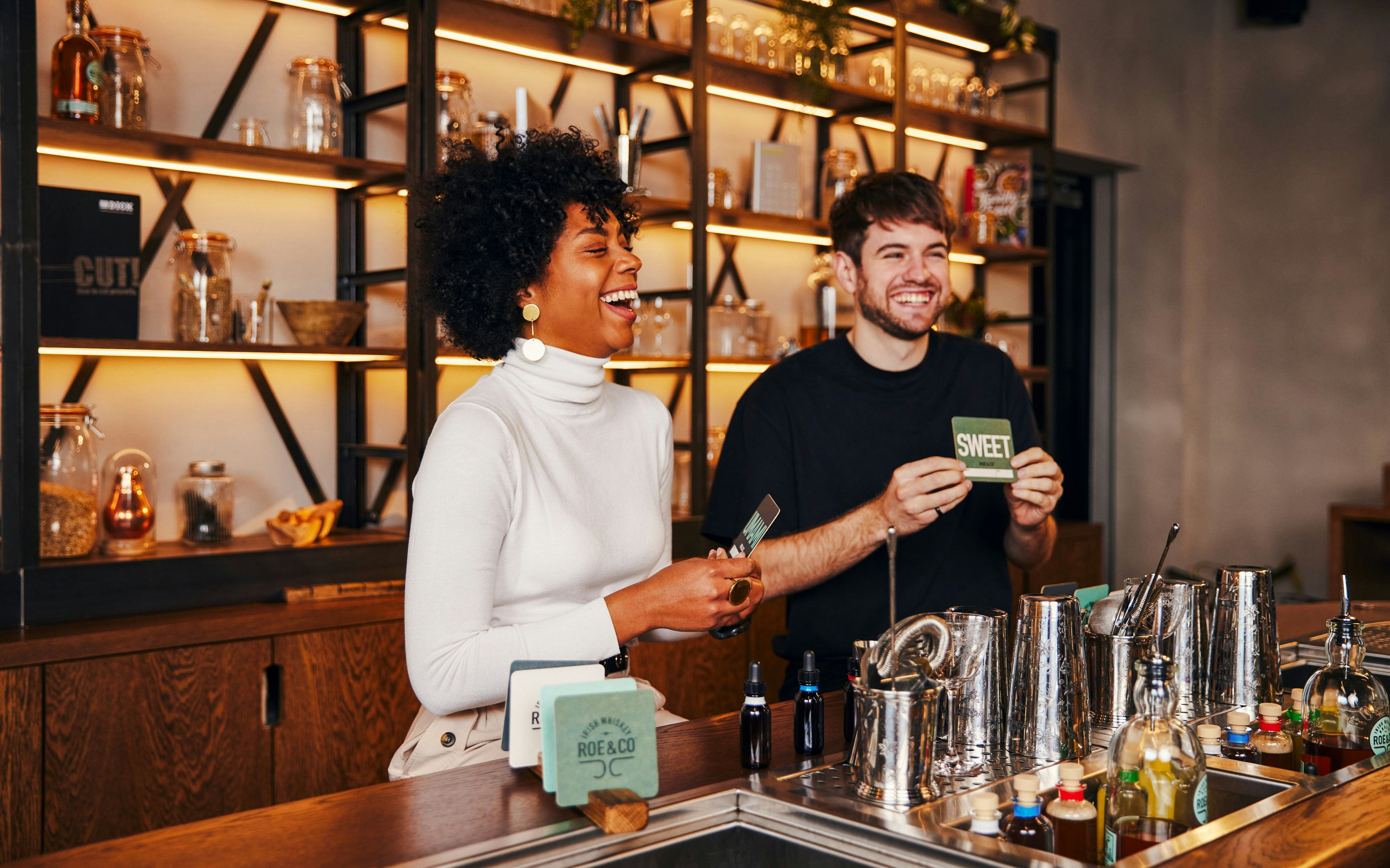Tourists enjoying a cocktail-making session at Roe & Co Distillery.