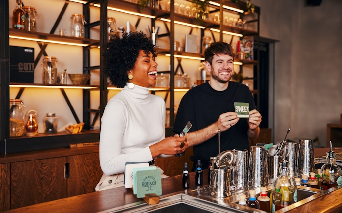 Tourists enjoying a cocktail-making session at Roe & Co Distillery.