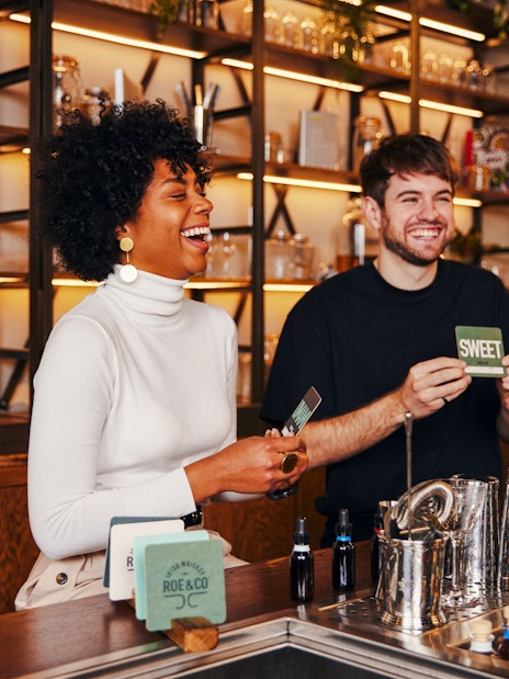 Tourists enjoying a cocktail-making session at Roe & Co Distillery.