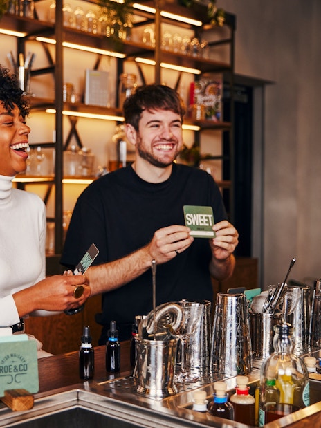 Tourists enjoying a cocktail-making session at Roe & Co Distillery.