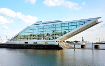 Dockland office building with glass facade overlooking the water in Hamburg, Germany.