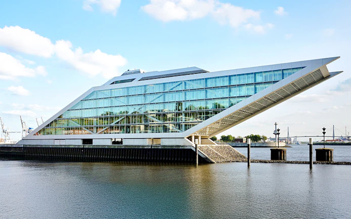 Dockland office building with glass facade overlooking the water in Hamburg, Germany.