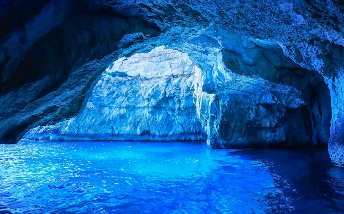 Blue Grotto cave with vibrant blue water, part of a guided tour experience.
