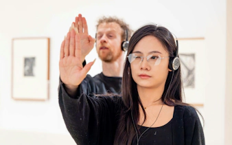 Visitors engaging with interactive exhibit at National Gallery of Victoria.