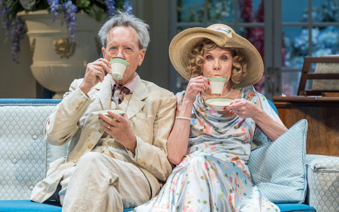Westend actors in period costumes sipping tea during HAY FEVER performance.