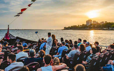 Tourists on a boat enjoying a sunset view over the water.