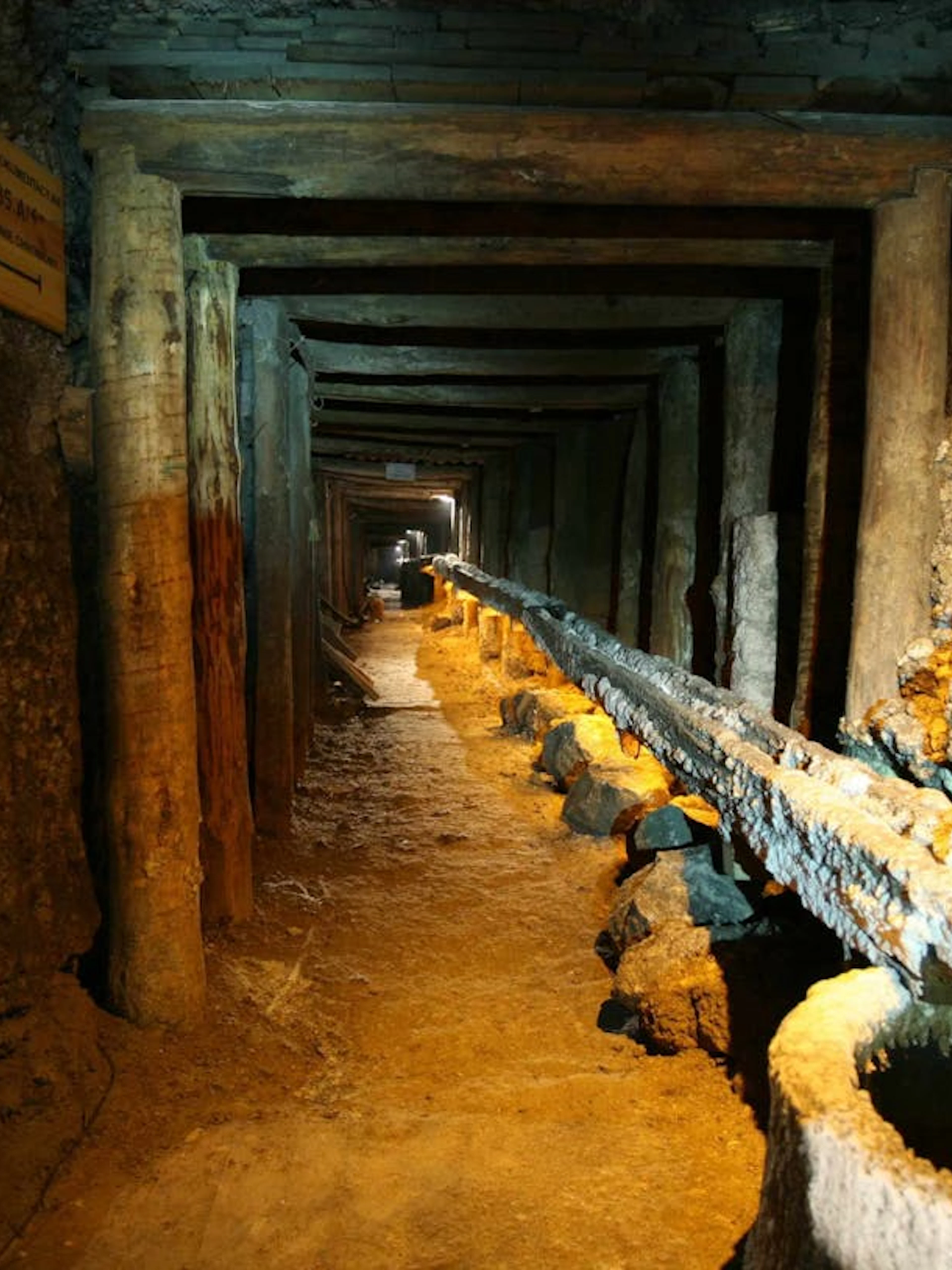 Wieliczka Salt Mine tunnel with wooden supports and brine flow, Krakow tour.