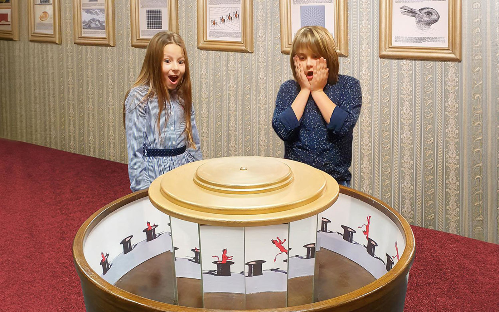 Guests reacting to optical illusion exhibit inside Museum of Fantastic Illusions.