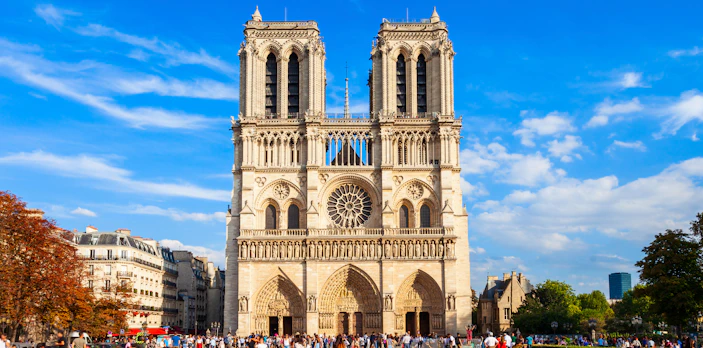 Notre Dame Cathedral facade with visitors in Paris, France.