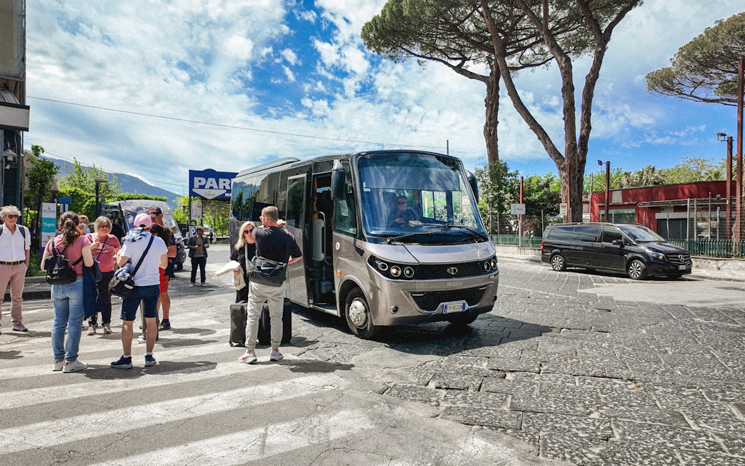 Transfer bus at Mount Vesuvius with tourists boarding.