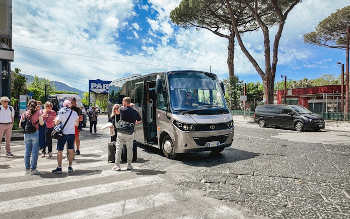 Transfer bus at Mount Vesuvius with tourists boarding.