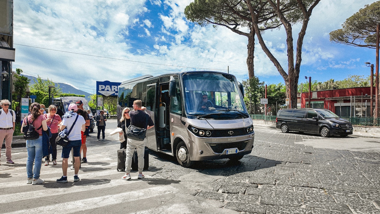 Transfer bus at Mount Vesuvius with tourists boarding.