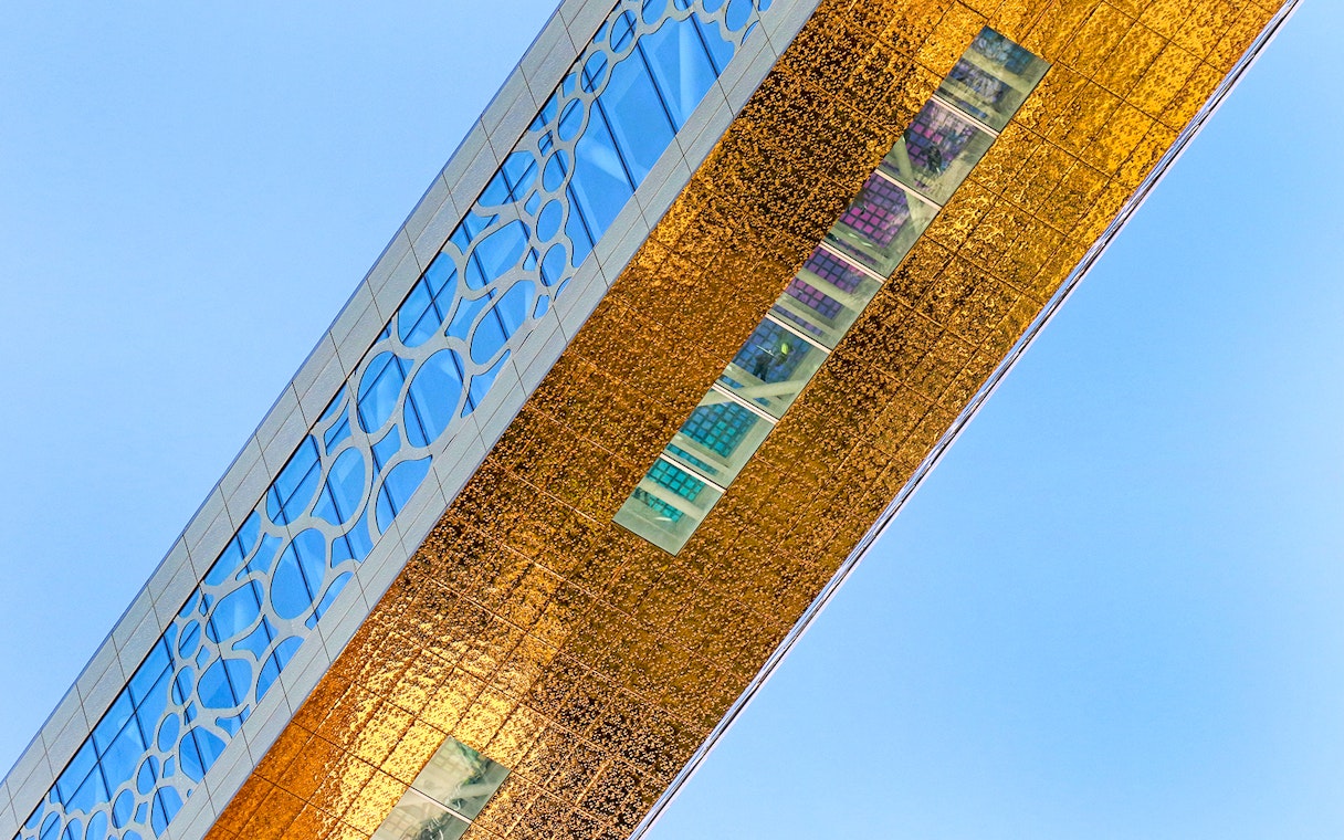 Dubai Frame detail with city skyline reflection, showcasing modern architecture in Dubai, UAE.
