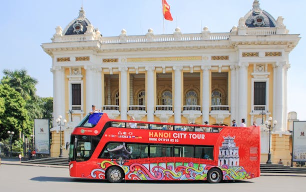 Hop on hop off bus in front of Hanoi Opera House, Hanoi, Vietnam.