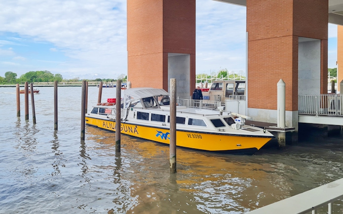 Alilaguna water bus docked at a pier in Venice, Italy.