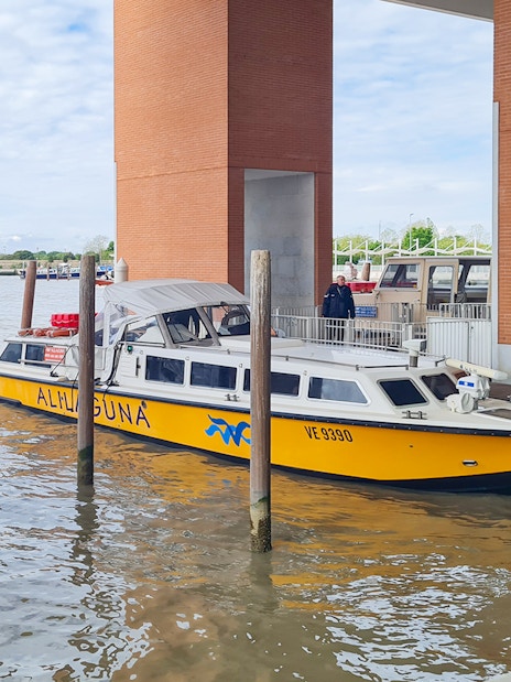 Alilaguna water bus docked at a pier in Venice, Italy.