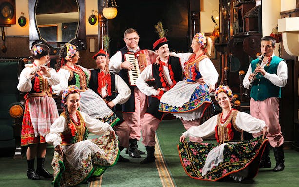 Folk dancers in traditional Polish costumes performing at Jama Michalika Cafe.