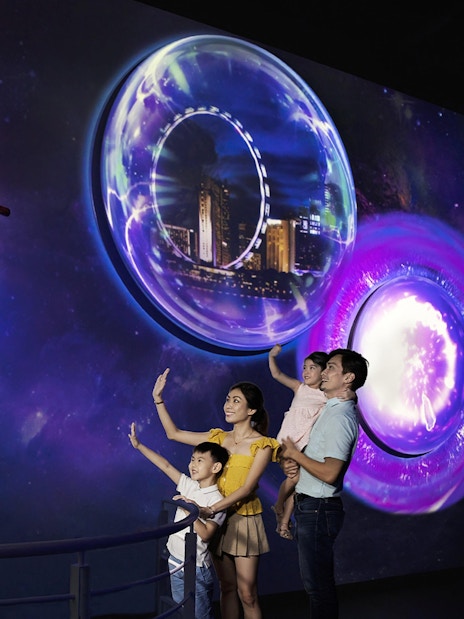 Family exploring interactive display inside the Time Capsule, Singapore.