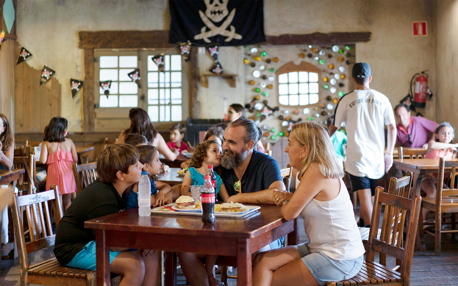 Family dining in pirate-themed restaurant at Isla Mágica, Seville.