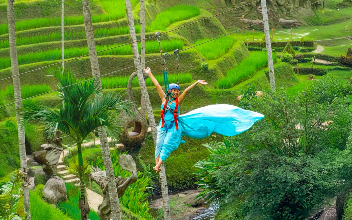 Lady ziplining over rice terraces at Alas Harum Bali.