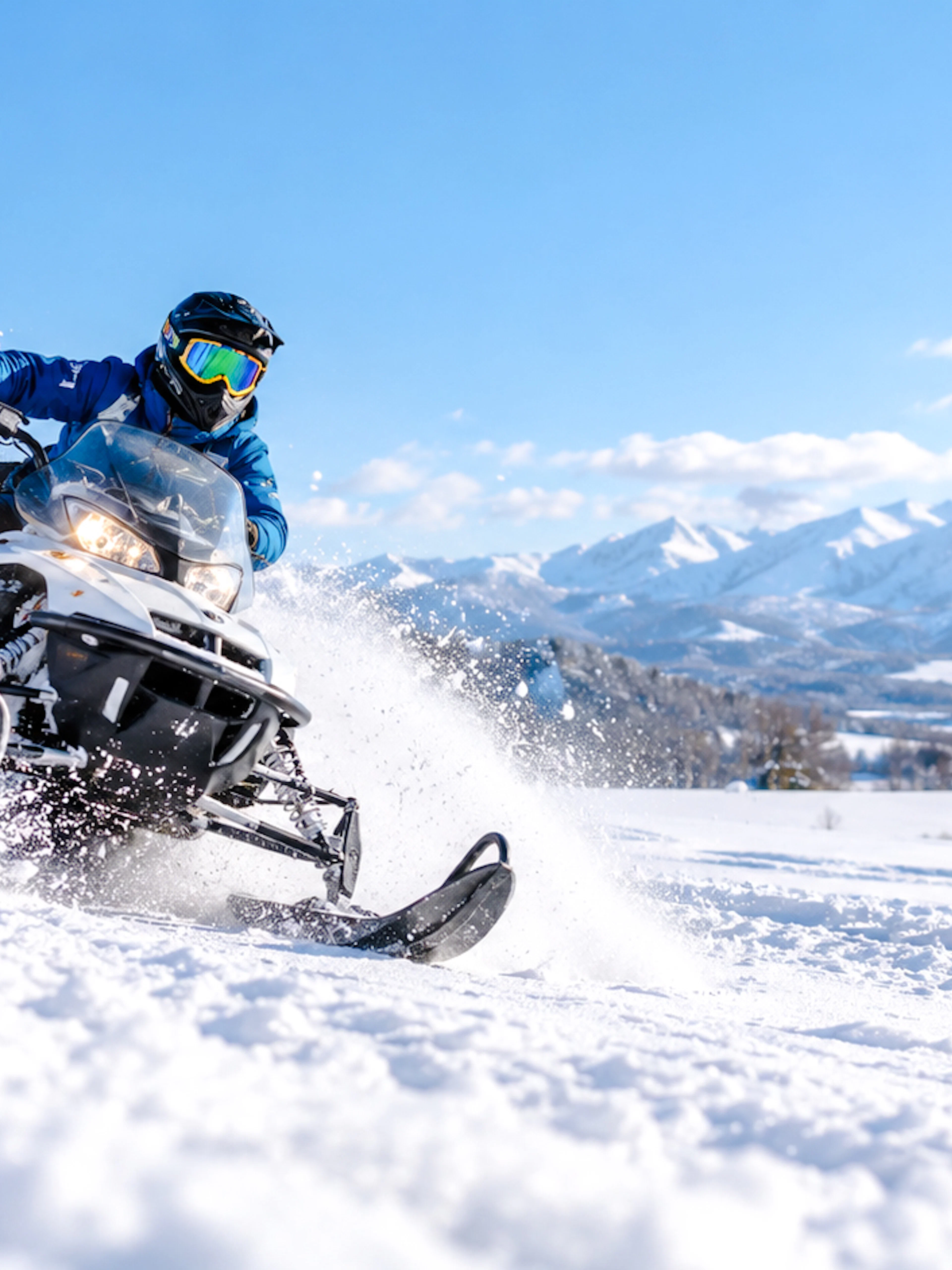 Snowmobile ride in snowy landscape with mountains, Sapporo, Hokkaido.