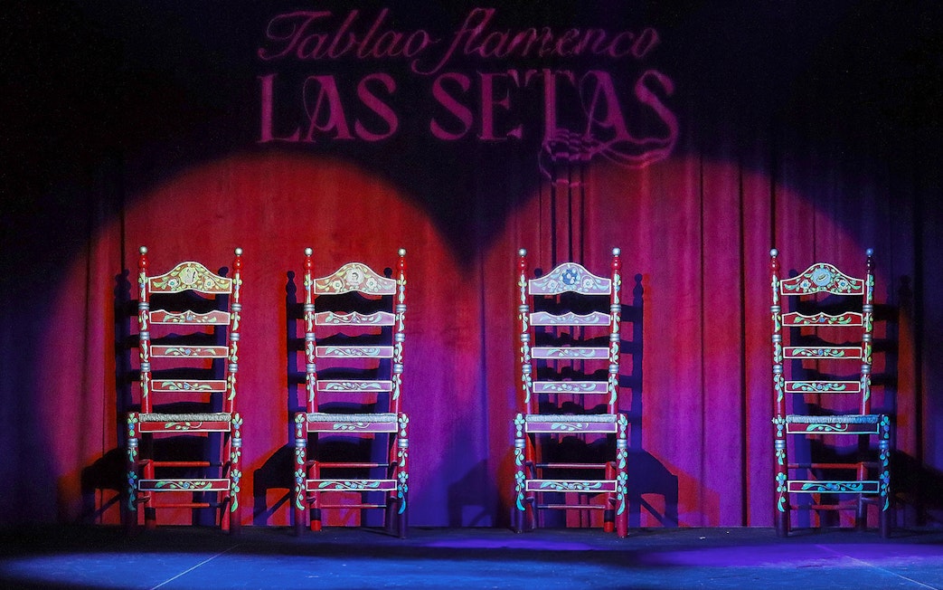 Four ornate chairs on stage at Tablao Flamenco Las Setas, Seville.
