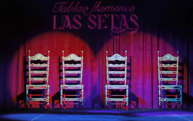 Four ornate chairs on stage at Tablao Flamenco Las Setas, Seville.