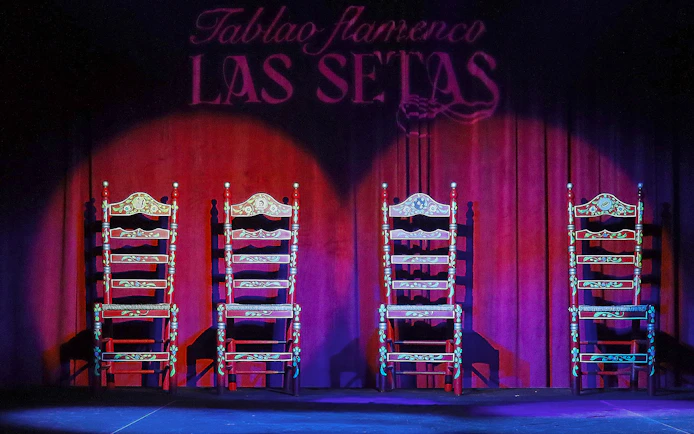 Four ornate chairs on stage at Tablao Flamenco Las Setas, Seville.