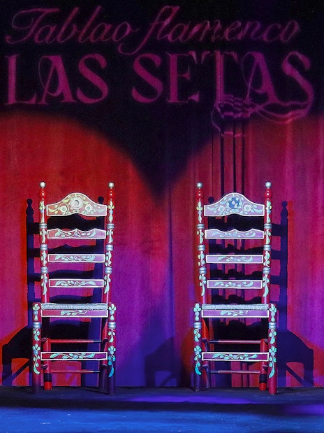Four ornate chairs on stage at Tablao Flamenco Las Setas, Seville.