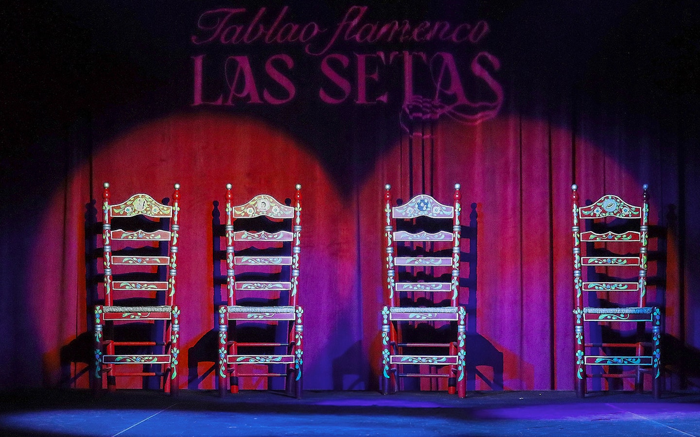 Four ornate chairs on stage at Tablao Flamenco Las Setas, Seville.