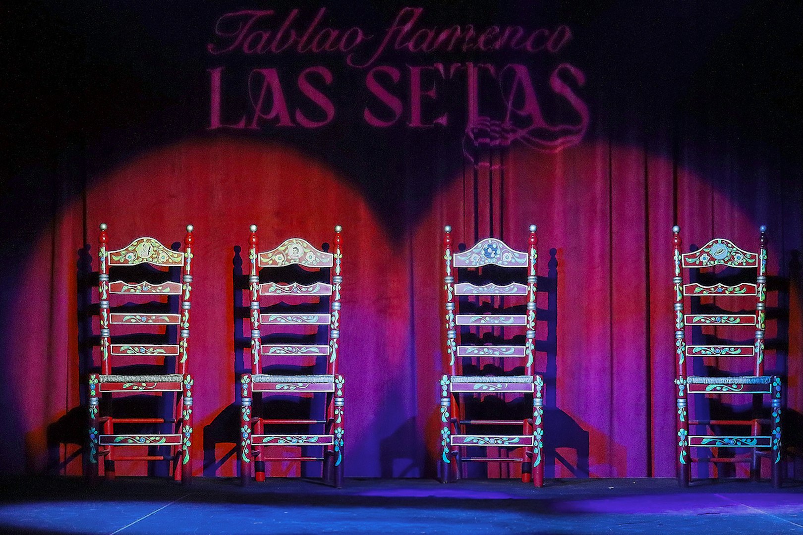 Four ornate chairs on stage at Tablao Flamenco Las Setas, Seville.