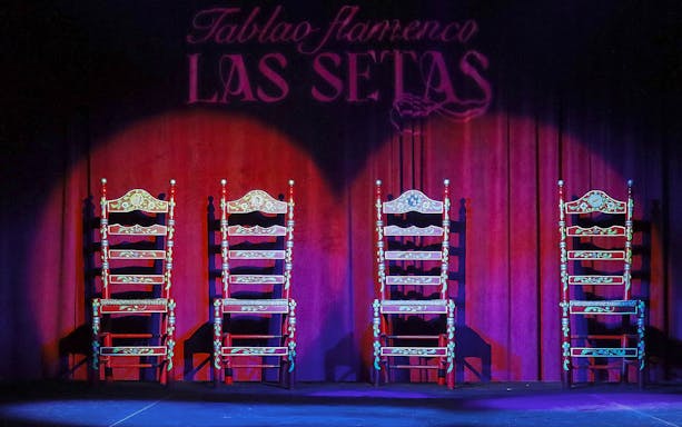 Four ornate chairs on stage at Tablao Flamenco Las Setas, Seville.